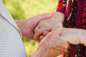 Elderly Couple Holding Hands 1200x798