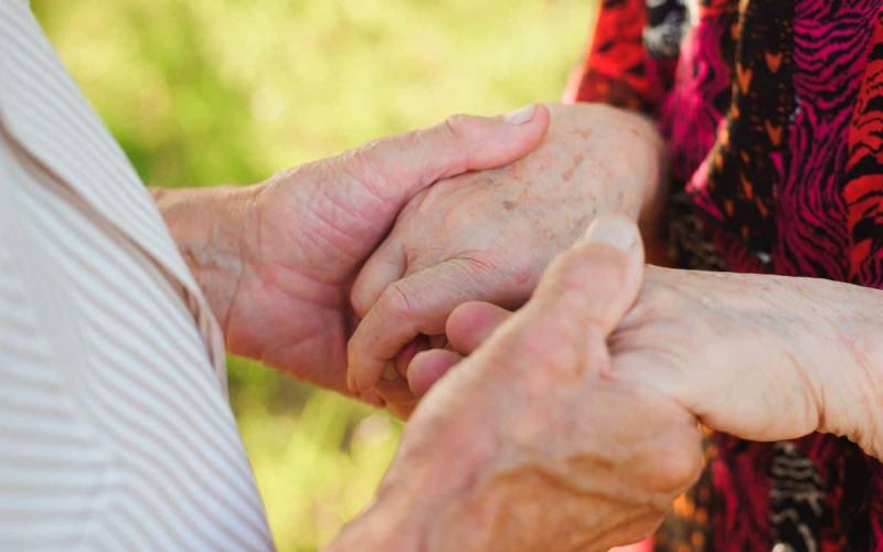 Elderly Couple Holding Hands 1200x798